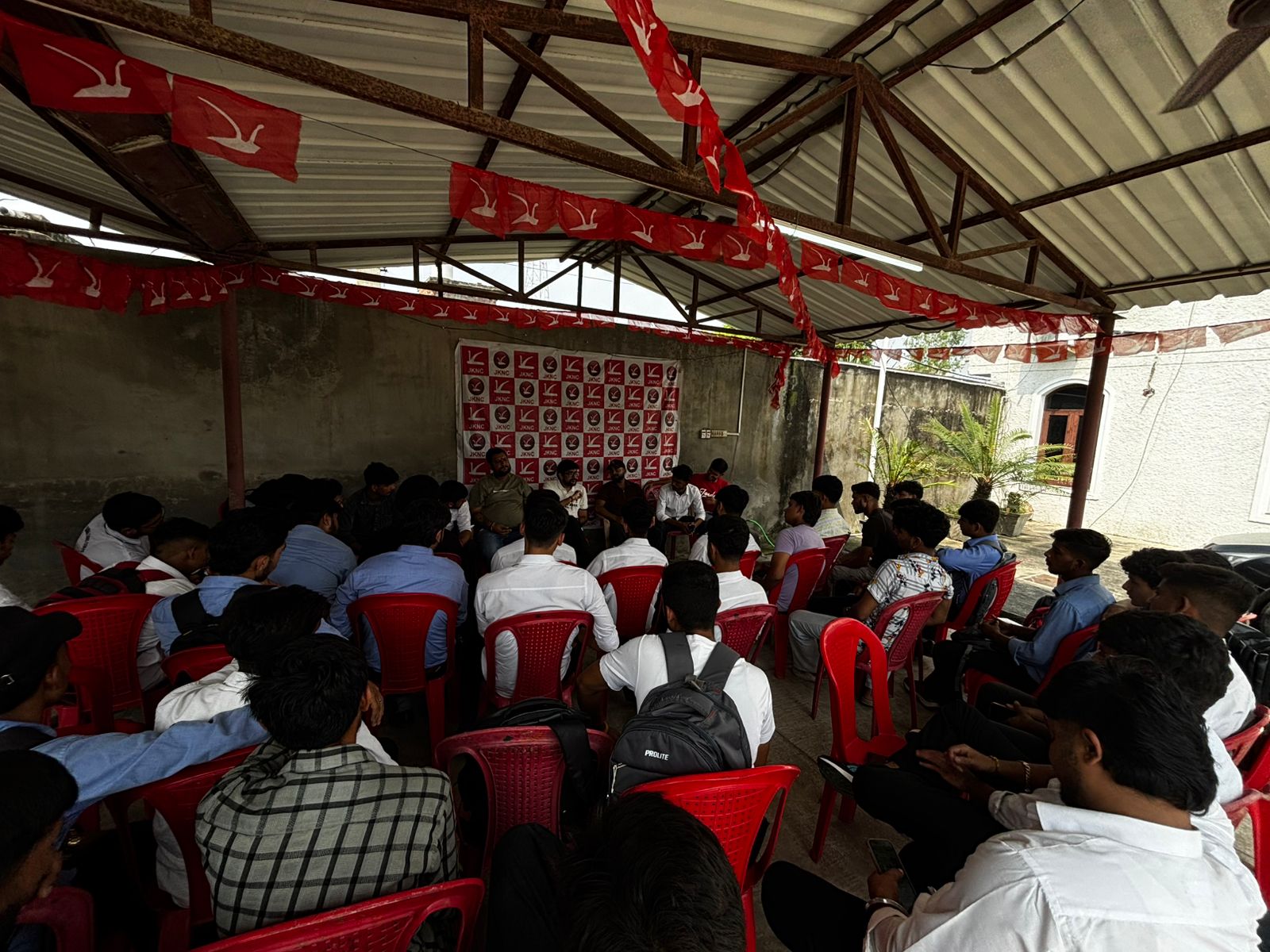 Meeting with Youth National Conference members under a shed