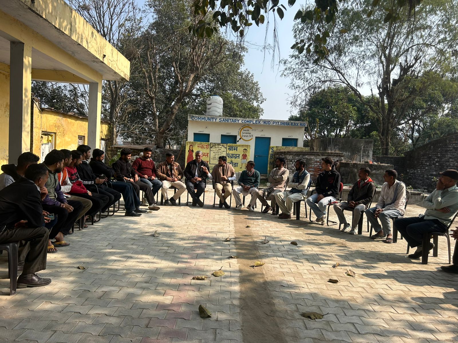 Holding a community meeting in a circle outdoors